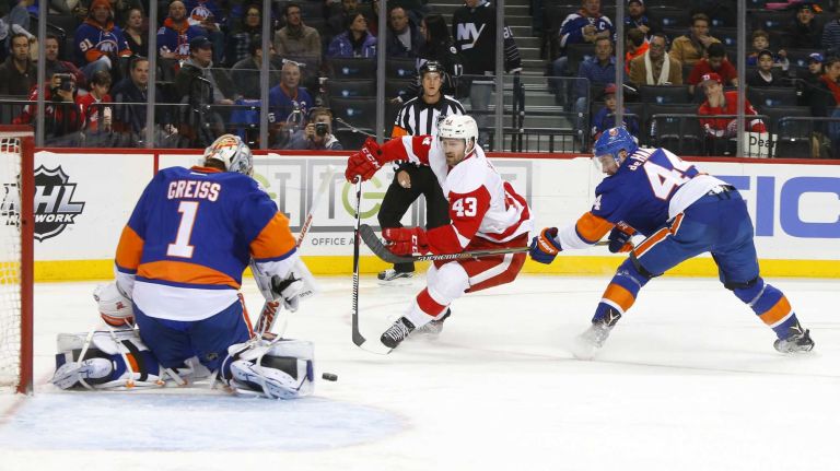 Darren Helm #43 of the Detroit Red Wings has a second period scoring chance stopped by Thomas Greiss #1 and Calvin de Haan #44 of the New York Islanders at Barclays Center on Monday, Feb. 15, 2016 in Brooklyn, New York.