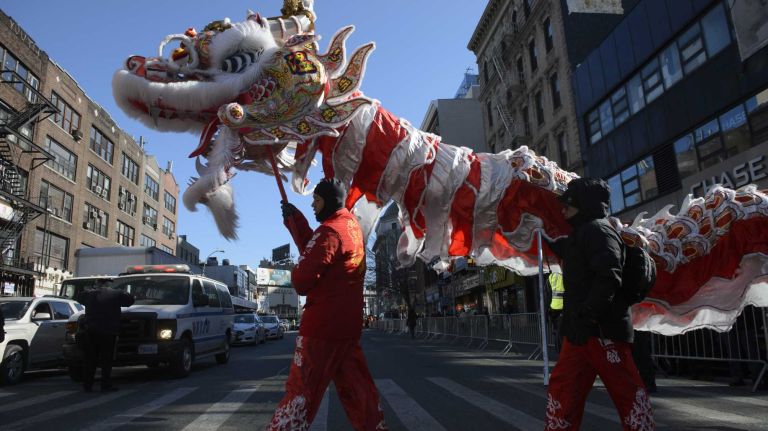 Participants and spectators carry a dragon during the annual Lunar New Year Parade in Manhattan's Chinatown on Sunday, Feb. 14, 2016. The Year of the Monkey is the ninth of the 12-year cycle of animals that appear in the Chinese zodiac, related to the Chinese calendar.