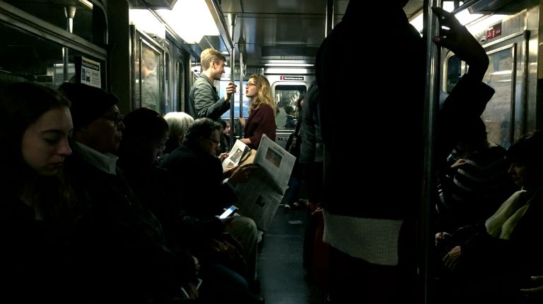 Subways are often a gold mine for street photographers and when most of the lights go out like on this downtown 1 train in October 2015, it is possible to capture moments like this between commuters. 