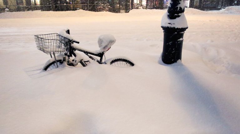 A bike is buried near Bryant Park as all cars but emergency vehicles are banned from driving on the road on Jan. 23, 2016, in New York City.