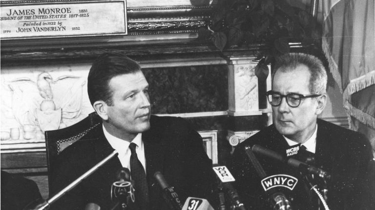 Mayor John Lindsay and U.S. Secretary of Labor W. Willard Wirtz speak to the press on Jan. 6, 1966, about the transit strike that would immobilize the city's subways and buses for 12 days. 