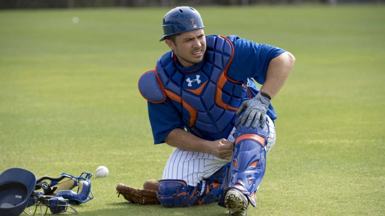New York Mets catcher Travis d'Arnaud stretches during a spring training workout on Sunday, Feb. 21, 2016 in Port St. Lucie, Fla.