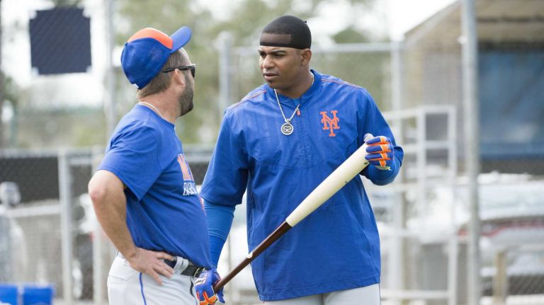 New York Mets outfielder Yoenis Cespedes talks to hitting coach Kevin Long after batting practice during a spring training workout on Sunday, Feb. 21, 2016 in Port St. Lucie, Fla.