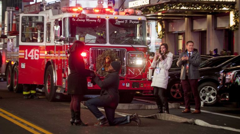 New Year's Eve in NYC 2015 to 2016: Pictures of the ball drop in Times Square and more 26 A couple's proposal before midnight during New Year's Eve in Times Square on Dec. 31, 2015.