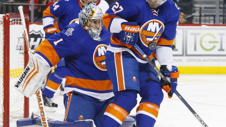 Anders Lee #27 and Thomas Greiss #1 of the New York Islanders defend a shot in the second period against the Detroit Red Wings at Barclays Center on Monday, Feb. 15, 2016 in Brooklyn, New York.