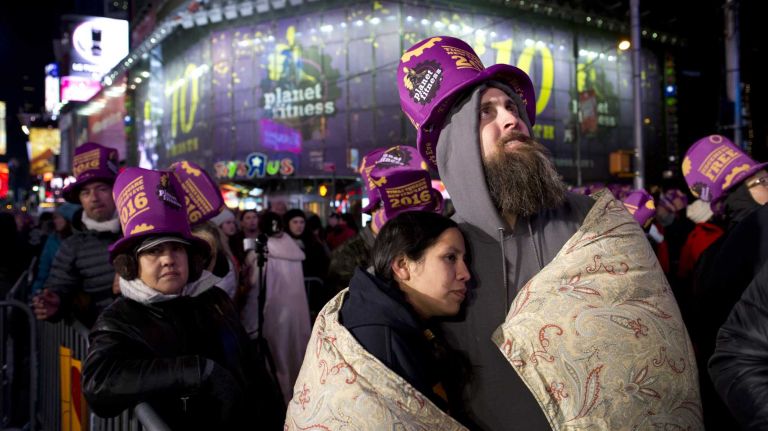 New Year's Eve in NYC 2015 to 2016: Pictures of the ball drop in Times Square and more 28 A couple warm themselves to celebrate New Year's Eve in Times Square on Dec. 31, 2015.