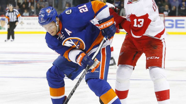 Kyle Okposo #21 of the New York Islanders battles for the puck in the third period against Pavel Datsyuk #13 of the Detroit Red Wings at Barclays Center on Monday, Feb. 15, 2016 in Brooklyn, New York.