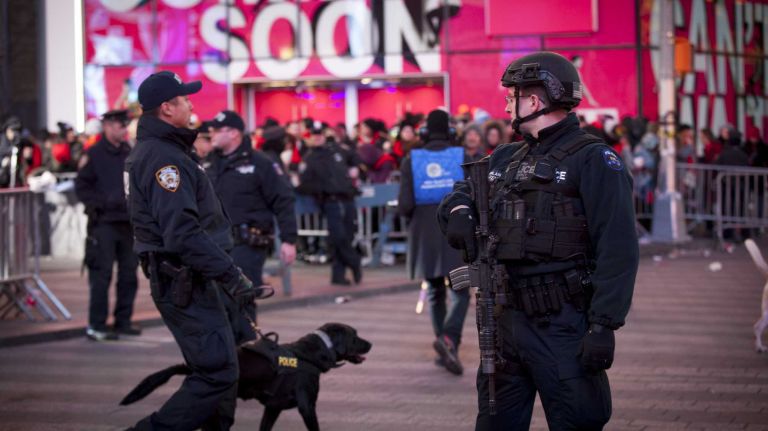 New Year's Eve in NYC 2015 to 2016: Pictures of the ball drop in Times Square and more 43 Police officers and a canine unit and counter terrorism unit secure Times Square during New Year's Eve festivities on Dec. 31, 2015.