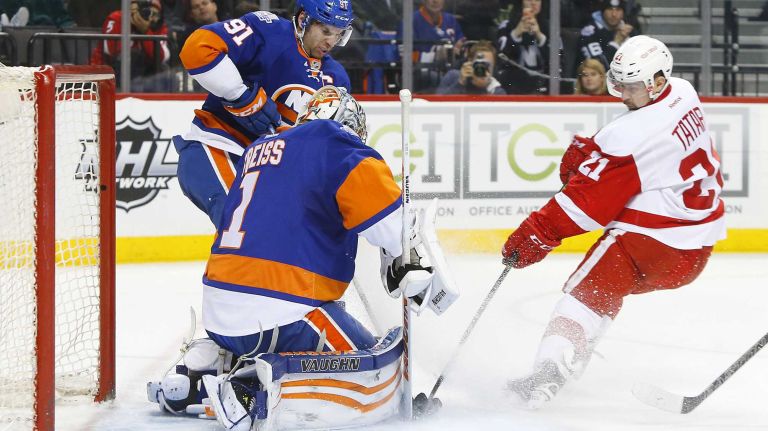 Thomas Greiss #1 and John Tavares #91 of the New York Islanders defend against Tomas Tatar #21 of the Detroit Red Wings during the second period at Barclays Center on Monday, Feb. 15, 2016 in Brooklyn, New York.