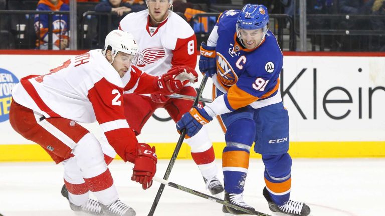 John Tavares #91 of the New York Islanders attempts a first period shot against Brendan Smith #2 of the Detroit Red Wings at Barclays Center on Monday, Feb. 15, 2016 in Brooklyn, New York.