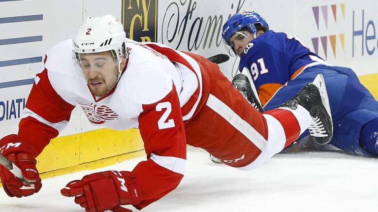 John Tavares of the New York Islanders commits a first period tripping penalty against Brendan Smith of the Detroit Red Wings at Barclays Center on Monday, Feb. 15, 2016.