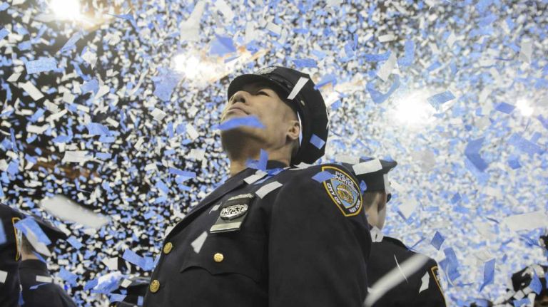NYPD officer graduations, Dec. 29, 2015 13 Newly sworn police officers are showered with confetti at the conclusion of the New York City Police Academy graduation ceremony at Madison Square Garden in Manhattan on Tuesday, Dec. 29, 2015. More than 1,200 new police officers participated in the graduation ceremony.