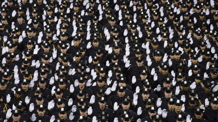 NYPD officer graduations, Dec. 29, 2015 14 New York Police Department Police Academy cadets are sworn in as police officers during their graduation ceremony at Madison Square Garden in Manhattan on Tuesday, Dec. 29, 2015.