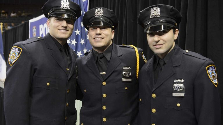 NYPD officer graduations, Dec. 29, 2015 16 Three brothers from Staten Island, Stephen Favale, left, John Favale, center, and Alec Favale, right, pose for a photograph prior to the New York Police Department Police Academy graduation ceremony at Madison Square Garden in Manhattan on Tuesday, Dec. 29, 2015. The three sons of a New York Police Department official were sworn in as officers, in what may be the first time three siblings have ever graduated from the city's police academy at the same time.