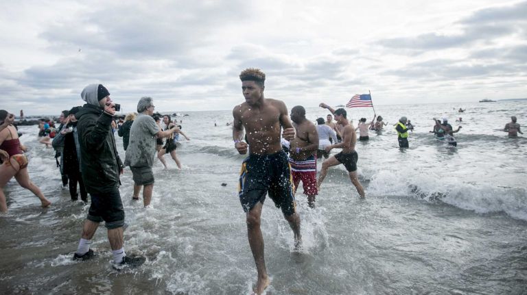 Swimmers take to the icy cold waters at the Coney Island Polar Bear Plunge in Brooklyn on Jan. 1, 2016.