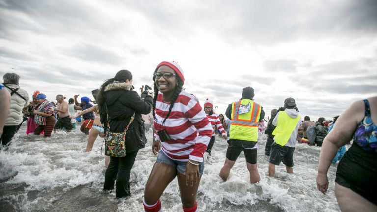 Swimmers and waders brave the water at the Coney Island Polar Bear Plunge in Brooklyn, on Jan. 1, 2016.