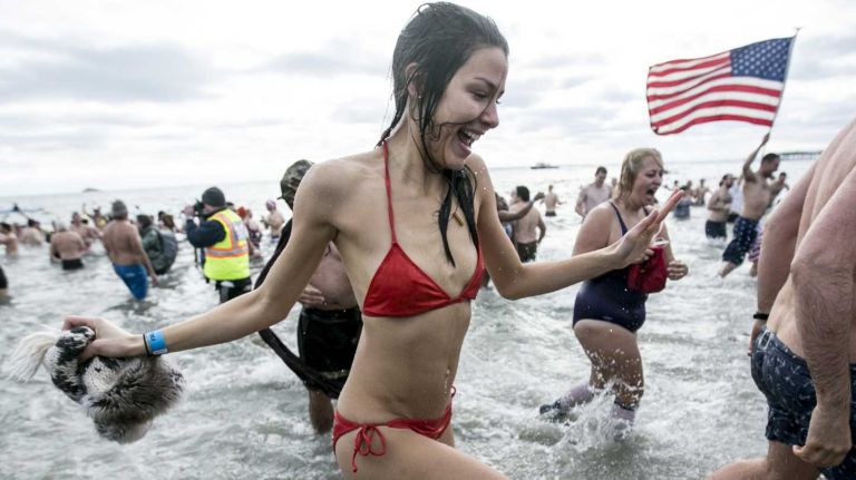 People jump in eagerly at the Coney Island Polar Bear Plunge in Brooklyn on Jan. 1, 2016.
