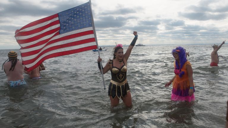People in bathing suits run into the ocean during the annual Coney Island Polar Bear Club New Year's Day swim on Jan. 1, 2016.