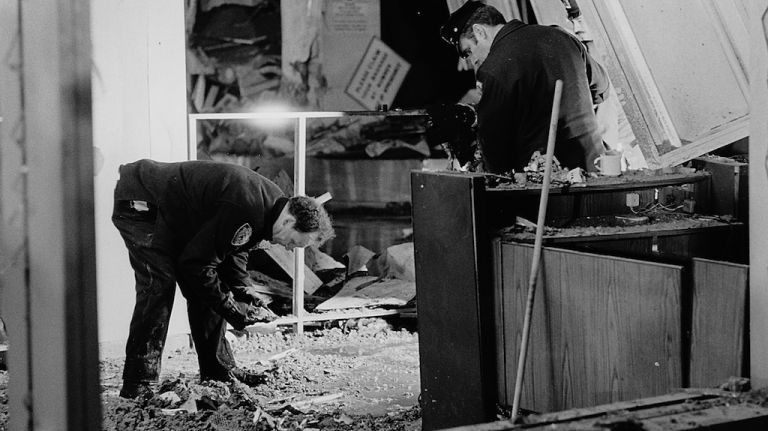 Police officers sift through debris searching for clues and pieces of the device which exploded inside the main terminal at LaGuardia Airport on Dec. 29, 1975. The bomb killed 11 people and injured 75, and was the deadliest act of terror in the city before Sept. 11, 2001.