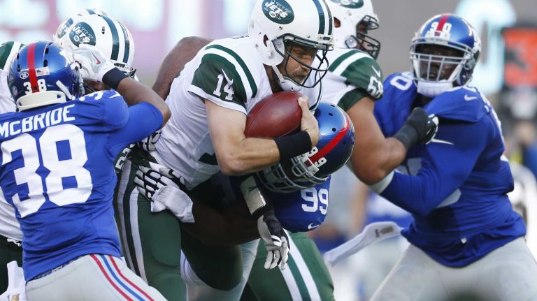 Ryan Fitzpatrick #14 of the New York Jets is sacked by Cullen Jenkins #99 of the New York Giants at MetLife Stadium on Sunday, Dec. 6, 2015 in East Rutherford, N.J.