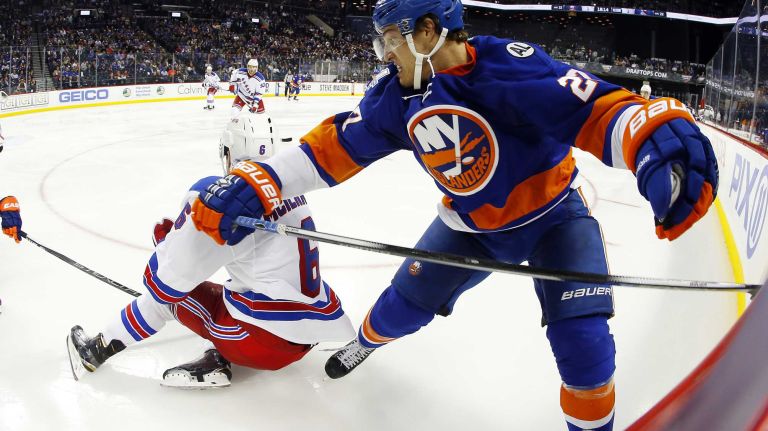 Anders Lee #27 of the New York Islanders battles against Dylan McIlrath #6 of the New York Rangers at Barclays Center on Wednesday, Dec. 30, 2015 in Brooklyn, New York.