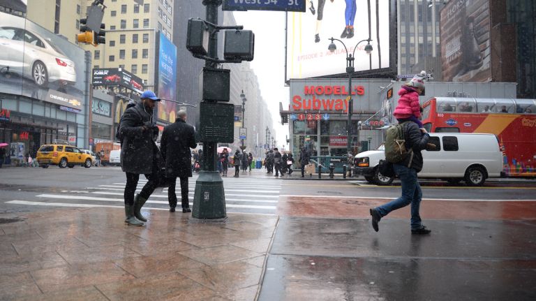 NYC weather: Light snow coats Manhattan 12 New Yorkers navigating through the flurries on Monday, Feb. 8, 2016, in Manhattan .
