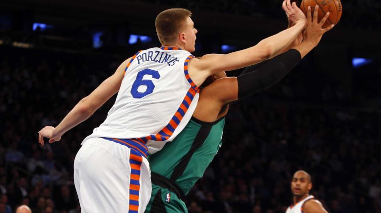 Kristaps Porzingis #6 of the New York Knicks defends a pass intended for Jared Sullinger #7 of the Boston Celtics in the first half at Madison Square Garden on Tuesday, Jan. 12, 2016 in New York City.