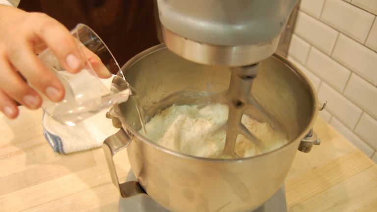 Add water, a little at a time, until combined. It should be flaky, not ball shaped.