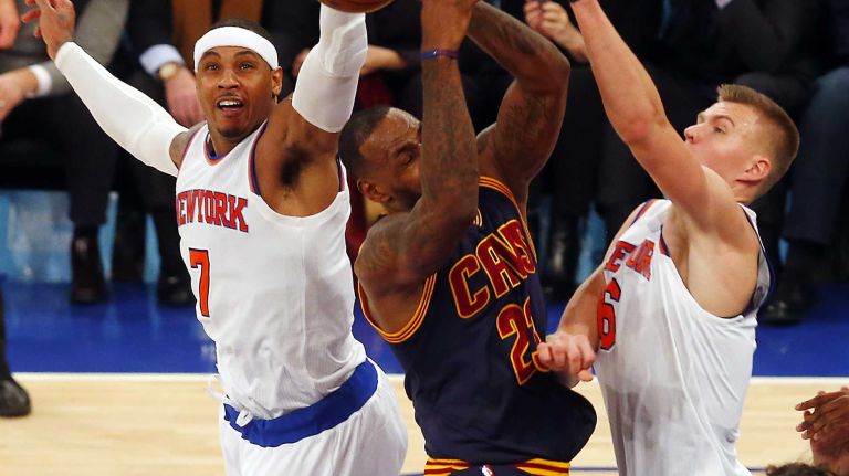 Carmelo Anthony #7 and Kristaps Porzingis #6 of the New York Knicks defend against LeBron James #23 of the Cleveland Cavaliers in the fourth quarter at Madison Square Garden on Friday, Nov. 13, 2015 in New York City.