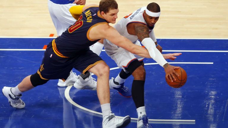 Timofey Mozgov #20 of the Cleveland Cavaliers and Carmelo Anthony #7 of the New York Knicks reach for a loose ball in the fourth quarter at Madison Square Garden on Friday, Nov. 13, 2015 in New York City.
