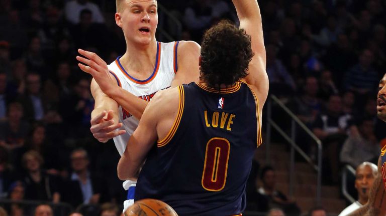 Kristaps Porzingis #6 of the New York Knicks looks to make a pass in the first quarter against Kevin Love #0 of the Cleveland Cavaliers at Madison Square Garden on Friday, Nov. 13, 2015.