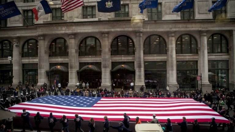 Participants hold a giant American flag as they march in the 96th annual New York City Veterans Day Parade in lower Manhattan on Wednesday, Nov. 11, 2015.