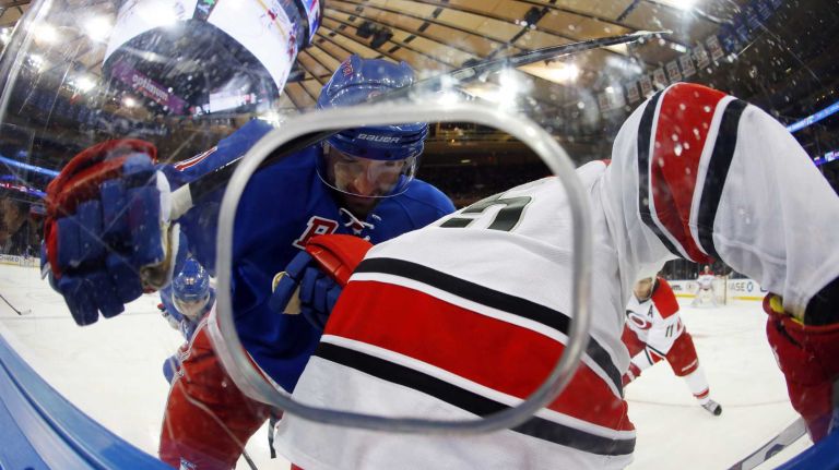 Rick Nash of the New York Rangers battles for the puck in the first period against Ron Hainsey of the Carolina Hurricanes at Madison Square Garden on Tuesday, Nov. 10, 2015.