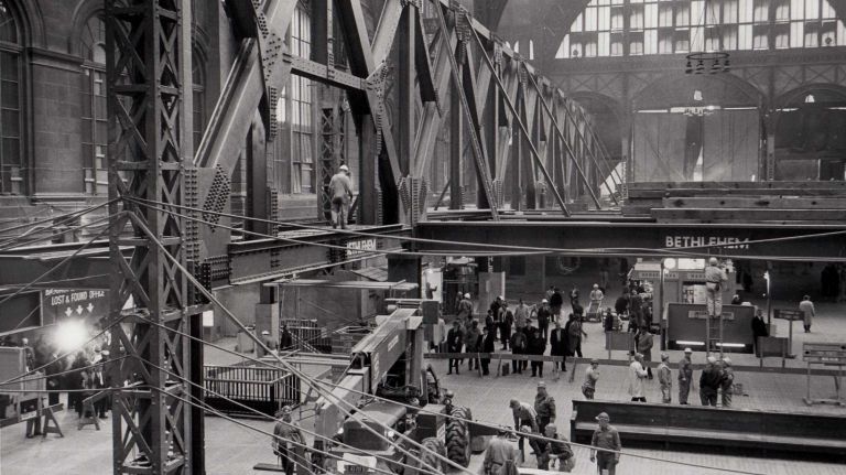 Heartbreaking photos of the demolition of the 1910 Penn Station, construction of Madison Square Garden 35 Penn Station under construction on Oct. 28, 1965. The rotunda of the station's waiting room has a network of steel girders being erected as a foundation for the new sports arena, Madison Square Garden. Passengers are seen waiting for trains while mingling with workmen in helmets.