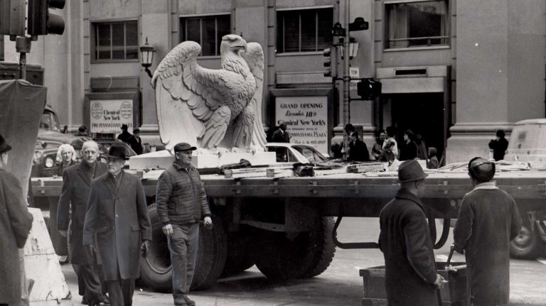 Heartbreaking photos of the demolition of the 1910 Penn Station, construction of Madison Square Garden 42 One of the two stone eagles that once adorned the old Penn Station rests on a flatbed truck on Feb. 7, 1968. The eagle is waiting to be transported to its permanent resting place in front of the new Penn Station, which is still under construction.