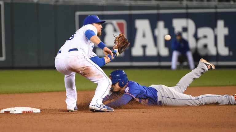 World Series Game 1: Mets vs. Royals 86 New York Mets center fielder Juan Lagares (12) steals 2nd base in the eighth inning as Kansas City Royals second baseman Ben Zobrist (18) waits for throw during Game 1 of the World Series against the Kansas City Royals at Kauffman Stadium on Tuesday, Oct. 27, 2015.