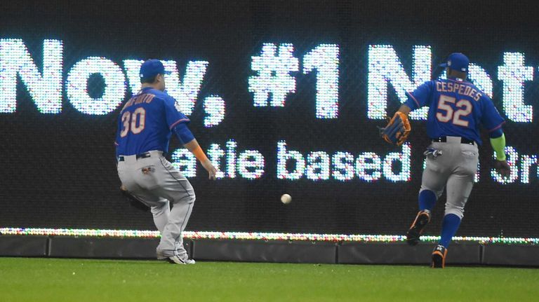 World Series Game 1: Mets vs. Royals 122 New York Mets left fielder Michael Conforto (30) and New York Mets center fielder Yoenis Cespedes (52) go after the loose ball hit by Kansas City Royals shortstop Alcides Escobar (2) in first inning for the inside the park homerun during Game 1 of the World Series against the Kansas City Royals at Kauffman Stadium on Tuesday, Oct. 27, 2015.