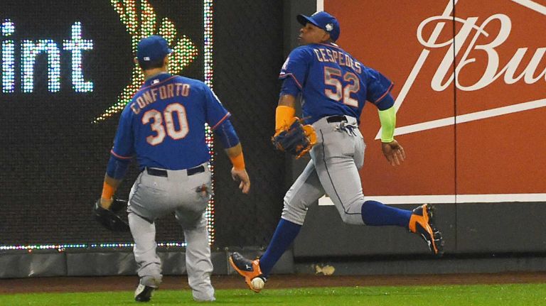 World Series Game 1: Mets vs. Royals 124 New York Mets left fielder Michael Conforto (30) and New York Mets center fielder Yoenis Cespedes (52) go after the loose ball hit by Kansas City Royals shortstop Alcides Escobar in first inning for the inside the park home run during Game 1 of the World Series at Kauffman Stadium on Tuesday, Oct. 27, 2015.