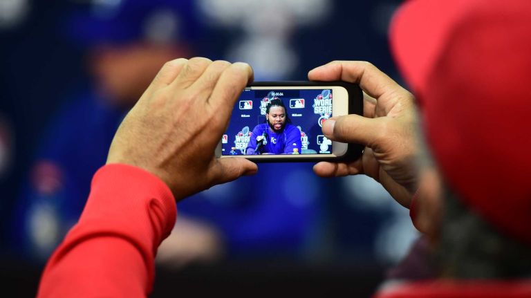World Series Game 1: Mets vs. Royals 147 Kansas City Royals starting pitcher Johnny Cueto (47) speaks at press conference as a member of the media records it on his mobile phone during Game 1 of the World Series against the Kansas City Royals at Kauffman Stadium on Tuesday, Oct. 27, 2015.