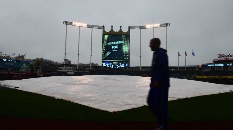 World Series Game 1: Mets vs. Royals 154 A worker walks on the grass in the home plate area as the tarp is on the field before Game 1 of the World Series against the Kansas City Royals at Kauffman Stadium on Tuesday, Oct. 27, 2015.
