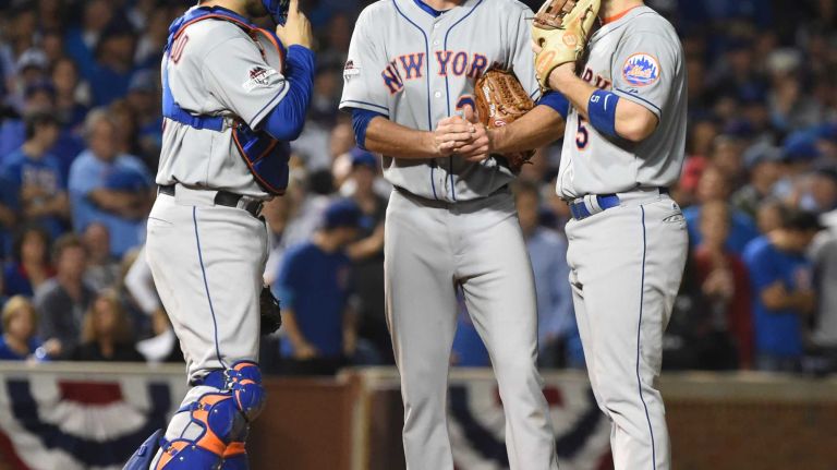 New York Mets catcher Travis d'Arnaud (7) and New York Mets third baseman David Wright (5) go to the mound to talk with New York Mets starting pitcher Steven Matz (32) in the fourth inning during Game 4 of the NLCS against the Chicago Cubs at Wrigley Field on Wednesday, Oct. 21, 2015.