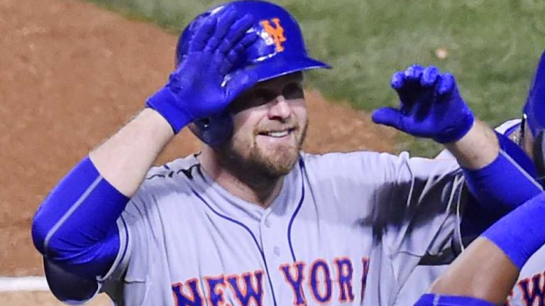 New York Mets first baseman Lucas Duda (21) is all smiles as he high-fives New York Mets centerfielder Yoenis Cespedes (52) after his three-run home run in the first inning during Game 4 of the NLCS against the Chicago Cubs at Wrigley Field on Wednesday, Oct. 21, 2015.