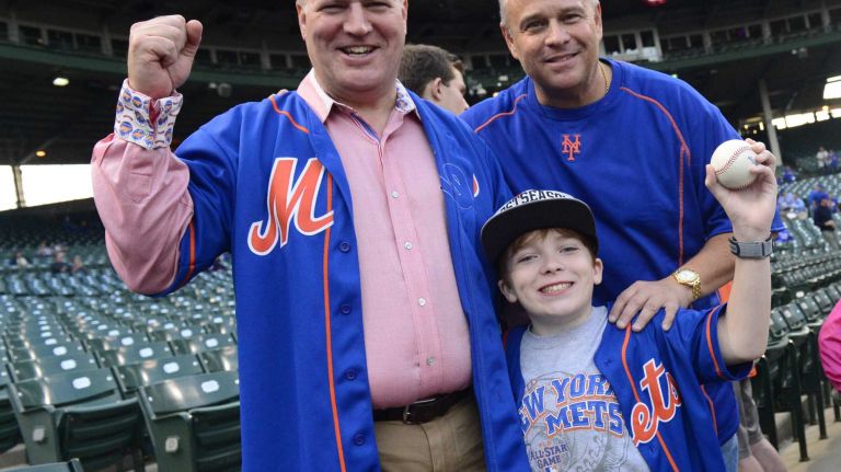 Michael Petruzzelli and his son Jake, 12, of Melville along with Andrew San Marco of Connecticut cheer on their New York Mets during batting practice befire Game 4 of the NLCS against the Chicago Cubs at Wrigley Field on Wednesday, Oct. 21, 2015.