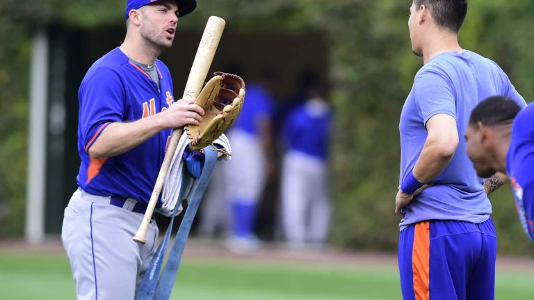 New York Mets third baseman David Wright (5) talks with New York Mets shortstop Wilmer Flores (4) as he walks to the batting cages prior to batting practice during Game 4 of the NLCS against the Chicago Cubs at Wrigley Field on Wednesday, Oct. 21, 2015.