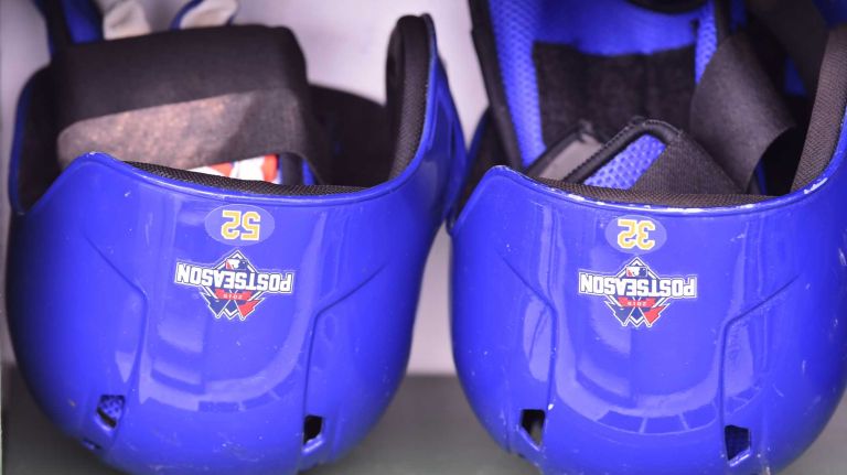 New York Mets center fielder Yoenis Cespedes (52) and New York Mets starting pitcher Steven Matz (32) helmets are in place in the dugout during Game 4 of the NLCS against the Chicago Cubs at Wrigley Field on Wednesday, Oct. 21, 2015.