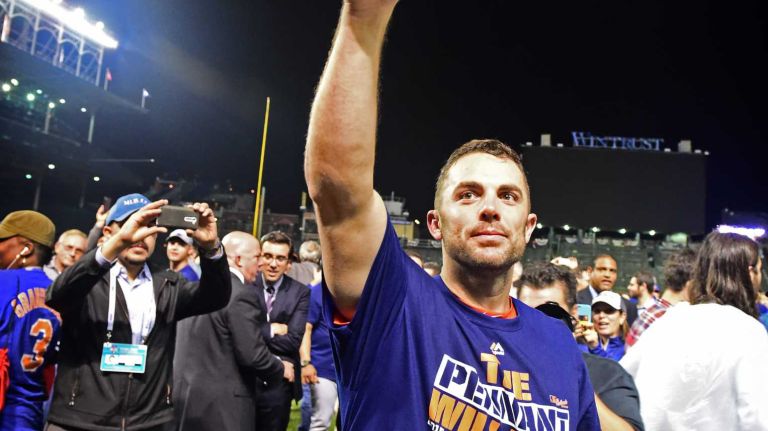 New York Mets Captain David Wright tips his hat to the crowd as he celebrates his victory in the NLCS against the Chicago Cubs at Wrigley Field on Wednesday, Oct. 21, 2015.