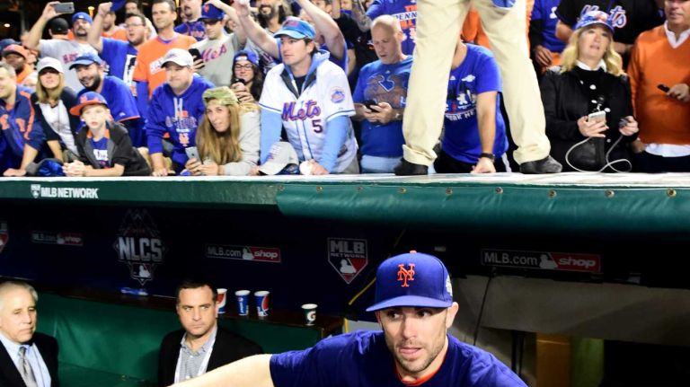 New York Mets Captain David Wright takes the field as he celebrates his victory in the NLCS against the Chicago Cubs at Wrigley Field on Wednesday, Oct. 21, 2015.