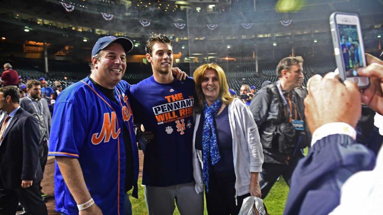 New York Mets Steven Matz poses for a photo with his parents on the field as he celebrates his victory in Game 4 of the NLCS against the Chicago Cubs at Wrigley Field on Wednesday, Oct. 21, 2015.