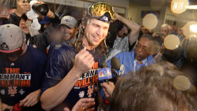 New York Mets starting pitcher Jacob deGrom (48) gets champagne all on his head as the New York Mets celebrate in the locker room the NLCS series win against the Chicago Cubs at Wrigley Field on Wednesday, Oct. 21, 2015.