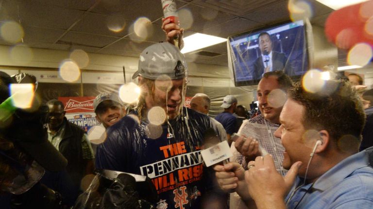 New York Mets starting pitcher Noah Syndergaard (34) gets champagne on his head as the Mets celebrate in the clubhouse after beating the Chicago Cubs in the NLCS at Wrigley Field on Wednesday, Oct. 21, 2015.